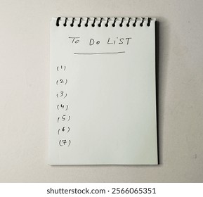 To do list work sheet on white background- hand written numbers 1 to 7 on writing pad, 