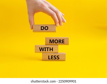 Do more with less symbol. Concept words Do more with less on wooden blocks. Beautiful yellow background. Businessman hand. Business and Do more with less concept. Copy space. - Shutterstock ID 2250909901