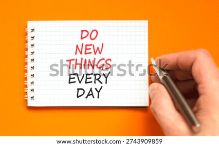 Do new things every day words symbol. Concept words Do new things every day on beautiful white note. Beautiful orange background. Business do new things every day concept. Copy space.