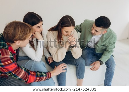 Do not be sad. A group of friends pleases a sad friend and supports her