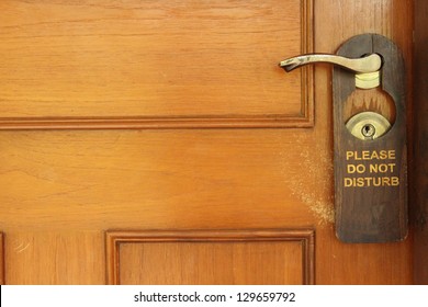 Do Not Disturb Sign Hanging On A Hotel Door Handle