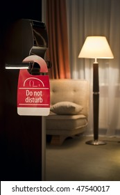 Do Not Disturb Sign Hanging On Open Door In A Hotel