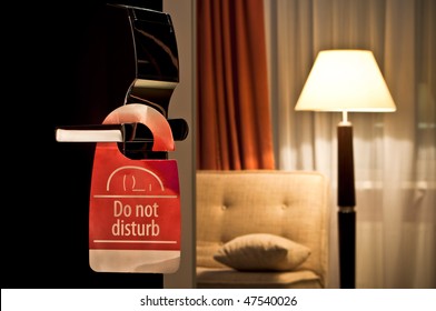 Do Not Disturb Sign Hanging On Open Door In A Hotel