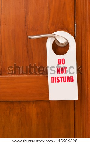 A do not disturb tag at the front of the hotel room