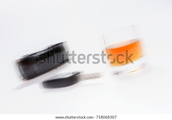 Do not drink and drive. Car keys next to a glass\
of brandy