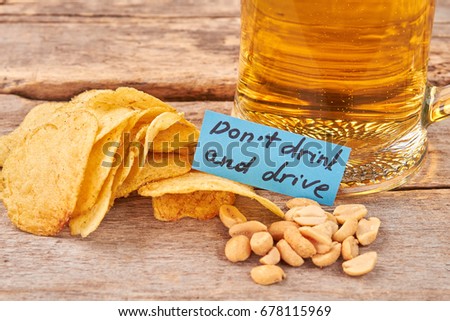 Do not drink and drive concept. Beer background, paper message.