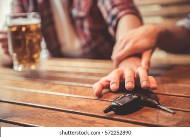 Do not drink and drive! Cropped image of drunk man talking car keys and his friend stopping him - Shutterstock ID 572252890