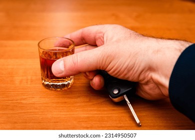Do not drink and drive. Drunk man hand with glass alcohol,car key in hand taking car keys. - Shutterstock ID 2314950507