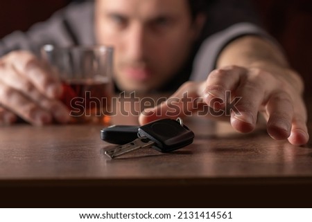 Do not drink and drive. Drunk man with glass alcohol in hand taking car keys. Foto stock © 