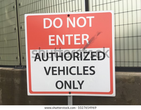Do not enter sign - authorized vehicles\
only text on metal sign at secure\
facility