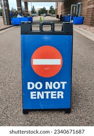 Do not enter stop sign on blue plastic portable folding sidewalk double sided sign stand on city street vertical photo. Access denied, closed path, forbidden enter, private property warning concept. - Shutterstock ID 2340671687