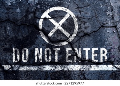 Do not enter text written and white line with broken cement wall, Do not enter sign word on street.