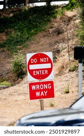 Do Not Enter Wrong Way red metal sign on the side of a road, at the entrance to a highway