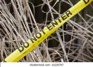 Do Not Enter Yellow Tape With A Dry Grass Background