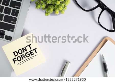 Do Not Forget Concept reminder on office desktop top view.