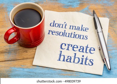 Do not make resolutions, create habits  - motivational advice or reminder on a napkin with a cup of coffee - Shutterstock ID 498039739
