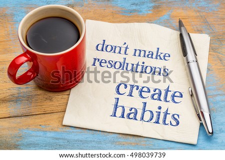 Do not make resolutions, create habits  - motivational advice or reminder on a napkin with a cup of coffee