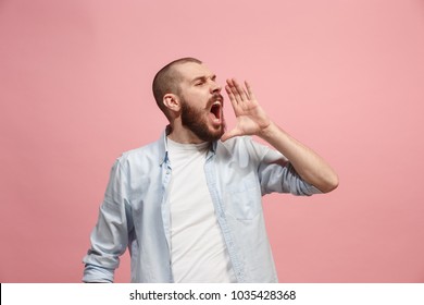 Do not miss. Young casual man shouting. Shout. Crying emotional man screaming on pink studio background. male half-length portrait. Human emotions, facial expression concept. Trendy colors - Shutterstock ID 1035428368