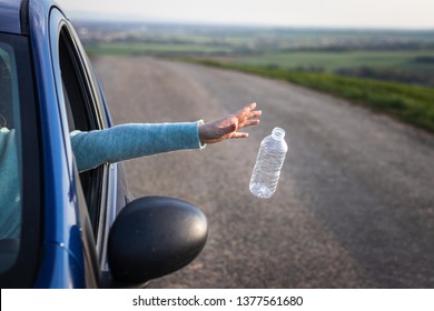 Do not pollute nature with plastic waste!  Driver throwing away plastic bottle from car window. Environmental conservation - Shutterstock ID 1377561680