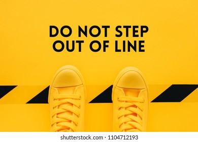 Do Not Step Out Of Line, Person In Yellow Sneakers Breaking The Rules And Acting In An Inappropriate Or Unacceptable Way