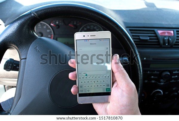 DO NOT use your\
cellphone while driving. Writing SMS while driving. Writing\
messages at the wheel. Concept about traffic safety. Romania,\
Bucuresti. September,29,\
2019