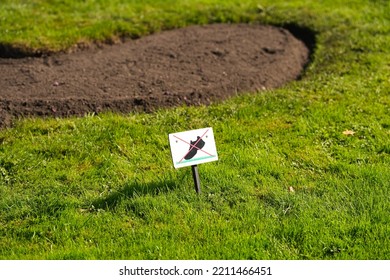 Do Not Walk On The Lawn Grass Sign Placed In A Beautiful Garden.