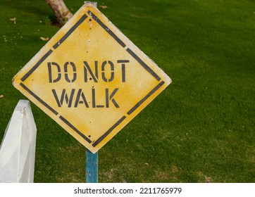 Do Not Walk Sign On The Grass. High Quality Photo