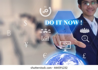 DO IT NOW  concept  presented by  businessman touching on  virtual  screen - image element furnished by NASA- SOFT SILVER TONE