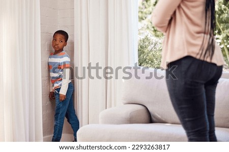 Do I really have to stand here. a little boy standing in the corner as a punishment at home.