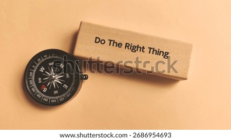 Do The Right Thing Text with a Compass on Wood Block Representing Moral Guidance, Ethics, and Direction