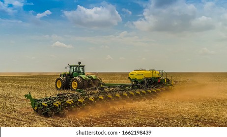 Chapadão do Sul / Mato Grosso do Sul / Brazil / February 26, 2020: Agriculture, aerial image, smooth tracking with drone and blue sky, zenith detail of the tractor that prepares the land for sowing