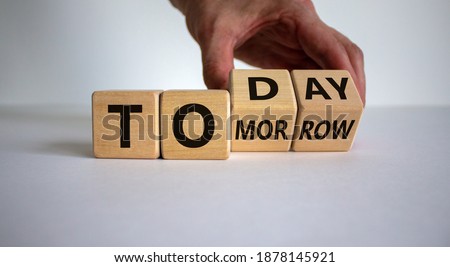 Do it today, not tomorrow. Male hand flips wooden cubes and changes the word 'tomorrow' to 'today'. Beautiful white background, copy space. Business and tomorrow or today concept.