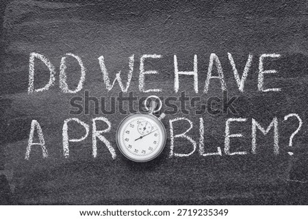 do we have a problem phrase written on chalkboard with vintage precise stopwatch