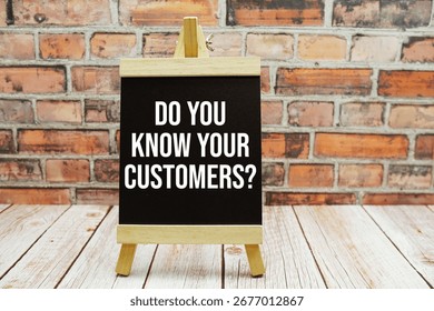 Do You Know Your Customers? text on blackboard easel stand on wooden and old brick wall background