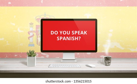 Do you speak Spanish on computer display with a flag of Spain in the background. Online lessons concept.