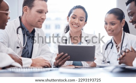 Do you think well be able to complete this. a group of doctors having a staff meeting while using a digital tablet.