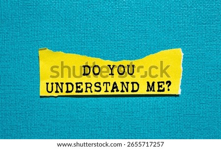 Do you understand me message written on ripped torn yellow paper piece on blue background. Conceptual do you understand me symbol. Copy space.