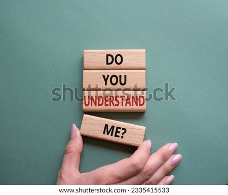 Do you understand me symbol. Concept words Do you understand me on wooden blocks. Beautiful grey green background. Businessman hand. Business and Do you understand me concept. Copy space. Conceptual 