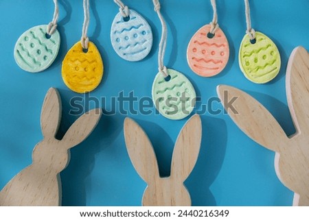 Do it yourself air dry clay crafts for Easter holiday. Decoration gift idea Handmade children craft. Step by step instruction of painting, pressing figures on blue background