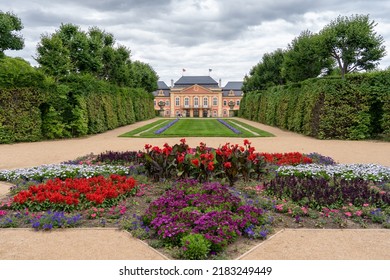 Dobris, Czech Republic - July 7, 2022: View of chateau Dobris and its ornamental garden with statues, flower beds and fountain owned by family Colloredo-Mansfeld