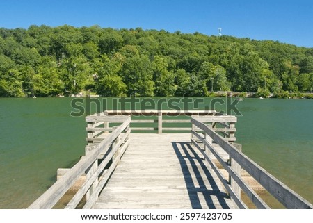 A dock extends onto the waters of Squantz Pond.