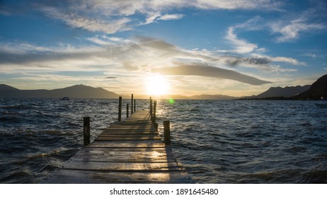 Dock In A Lake At Sunset