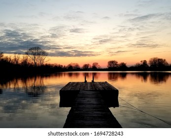 Dock On Lake With Sunset