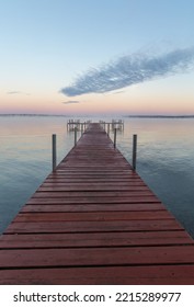 Dock On Mullett Lake In Indian River Michigan With Pastel Skies Overhead