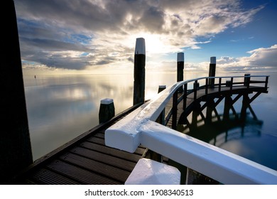 A Dock In The Wadden Sea With A Cloudy Sky Over It