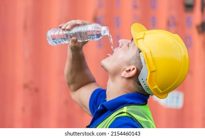 Dock Worker Man Wearing Safety Helmet Drinking Water At Containers Cargo