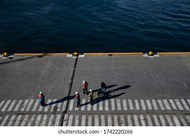Dock workers taking a break while people are boarding their cruise in Ushuaia to explore Patagonia