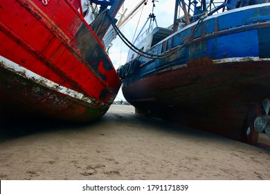 Docked Fishing Boats In Low Tide.