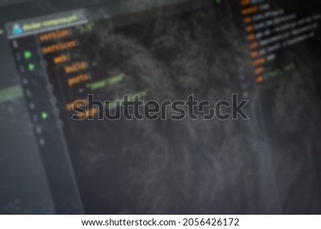 Docker compose Hello World code on screen blurry background image