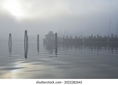 The docks at Port Jefferson Harbor in morning fog.  Copy space. Port Jefferson, New York, USA.